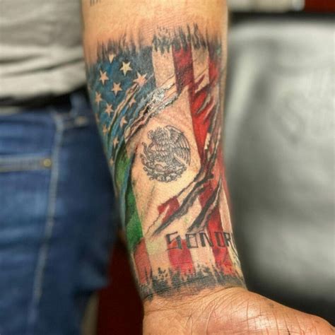 The Mexican American flag tattoo typically features the colors red, white, and green in horizontal stripes. The red symbolizes the blood shed for liberation and revolution, whereas the white stands for peace and unity between two nations. The green represents hope for a prosperous future.. 