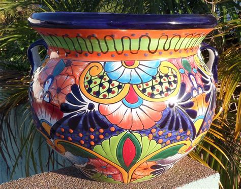 Mexican pottery planters. Large Talavera Planter. Adding your items... These delightful Talavera Planters embody all the charm of Mexican Talavera. Featuring intricate floral patterns and classic, multi-colored designs, these striking Talavera planters will beautify any home or garden. Usable indoors or out, all our ceramic planters also include a convenient drain hole. 