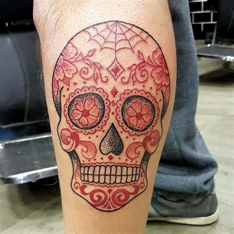 Mexican sugar skull tattoo. Cher Llyod’s Sugar Skull Tattoo on Bicep. Cher Lloyd got inked with a sugar skull and a rose on her bicep in July 2011. The design is pretty unique and the skulls are covered in a lot of beautiful flowery swirling patterns. It is also added with a diamond on the forehead and two red hearts in place of the eyes. 