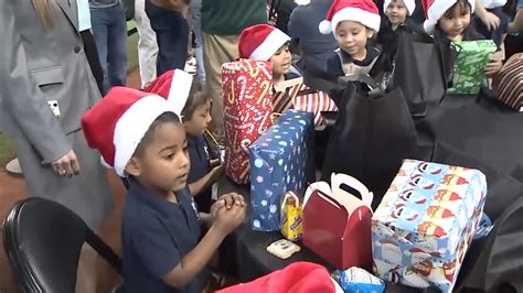 Miami Marlins hand out presents to children at loanDepot Park
