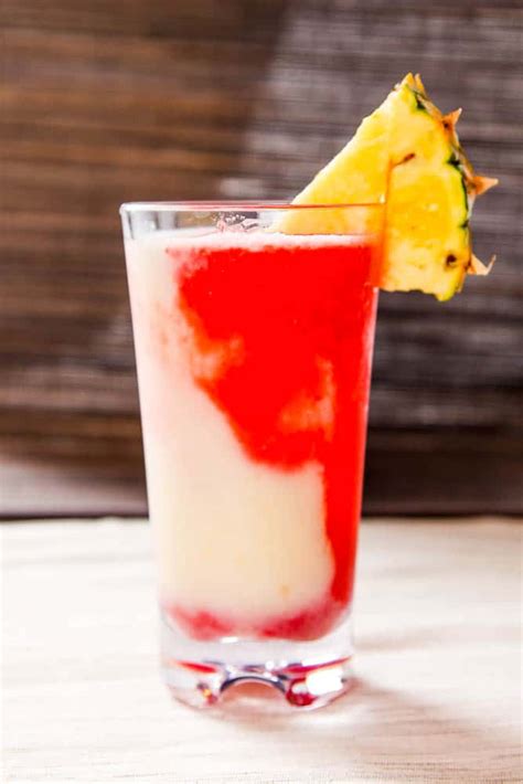 Miami vice drink. Combine pina colada mix with 2.5 oz of rum and ice – add enough ice to make a thick mix. Set aside. Combine daiquiri mix with 2.5 oz of rum and ice. Again, add enough ice to make it nice and thick. Pour pina colada and daiquiri mixture into a tall glass at the same time. If that gets a bit too messy, alternate pours. Garnish with strawberries. 