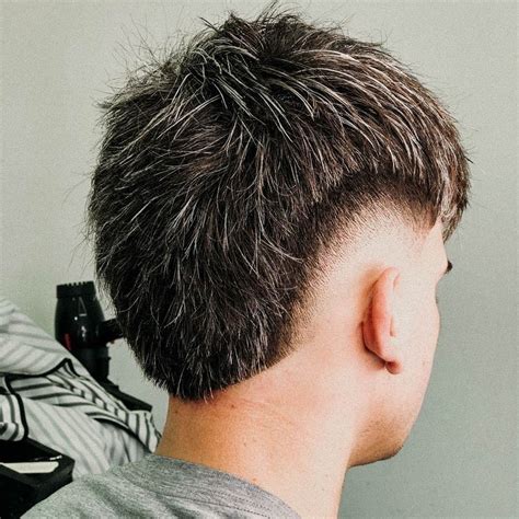 Mid burst fade straight hair. The sides: Your barber will scissor-taper the hair near the top and then transition to a clipper fade that bursts around the ear, giving the ‘burst’ its name. The top: Keep the hair longer to create that iconic pomp volume. Use a blow dryer and round brush for height and control. 