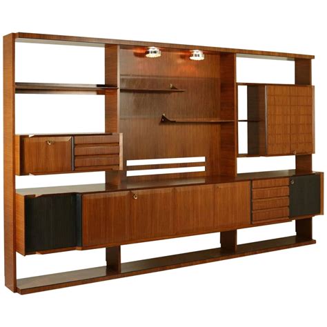 Mid century modern wall unit. Let’s face it. Even the most diehard of minimalists need a place to keep and show off their favorite items. That’s when a well-designed bookcase or wall unit can be worth its weight in gold. And if minimalism is the last term you’d use to describe your décor tendencies, it might be prudent to add several bookshelves and wall units to ... 