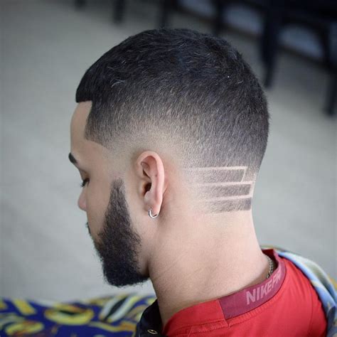 Mid fade designs. The high taper combined with a higher neckline gives the illusion of a low fade, creating a distinct diagonal line at the back of the head. This design concentrates the hair volume above the ears, whether the afro is styled with texture or kept smooth. 2. Afro Taper Fade Mid 