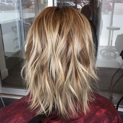 2. Sleek and Straight Medium-Length Layers. This chic hairstyle is a blunt bob with a modern look. The expertly blended highlights and soft, rounded layers enhance the sleek cut, providing depth and an illusion of fuller hair. 3. Wispy Layers with Bangs.. 