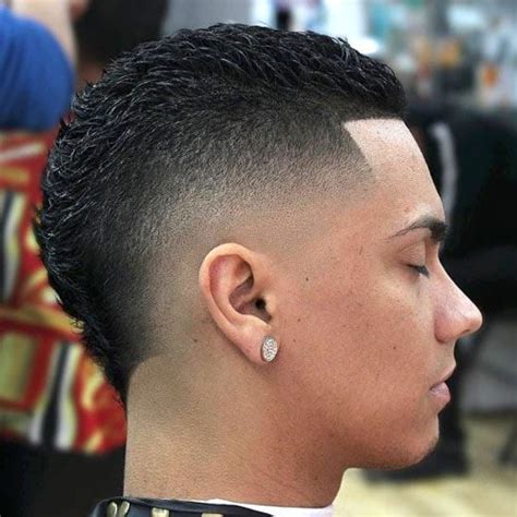 High Fade Comb Over. This photo is a great example of a high fade comb over. The hair on the sides and back is shaven to the scalp very high up the head. Just below the length, you will notice some fade to blend the cut more subtly. This cut is also known as a high top fade due to the excessive length left on top.. 