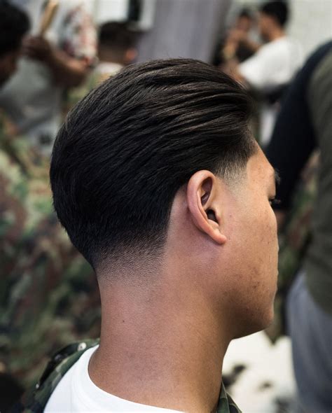 Oct 7, 2023 · 7. Rockabilly Hairstyle. Save. This is a great twist to the classic slick back fade style. Simply ask your barber to fade out the sides of your head, but as you get closer to the top, ask him to give you a sharp line cut that divides the long part of your hair from the short one.. 