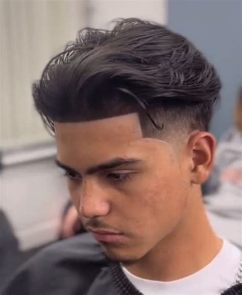 Jan 9, 2023 · This look combines it with a slick back. It looks great if you have a round face shape. With this face, you need to decide between pomade vs. wax vs. gel vs. clay based on which one works best for you. Middle Part For Mexican Men. The Mexican middle part look is best for guys with thick hair. Work some pomade through your hair and part it down ... . 