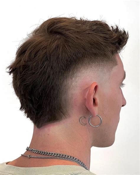 Middle part burst fade. Burst Fade Mullet. A burst fade mullet puts a popular dapper spin on a contemporary cut. A quiff at the front is sophisticated and stylish, and handsome layers create a subtle transition to the shorter hair at the back. A dynamic, assertive burst fade creates the illusion of additional volume amplified by a clean-shaven face. 