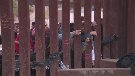 Migrants huddle at the border as food, water, shelter in short supply