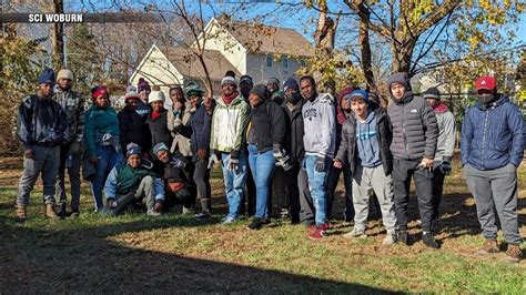 Migrants join volunteers to rake leaves for senior citizens in Woburn