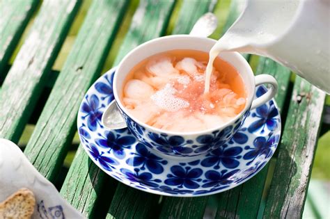 Milk in tea. The Brits' habit of adding milk to tea dates back to the 18th century, when tea was brewed in pots and china cups were expensive. It was a way to cool down the tea and reduce its bitterness, and it … 