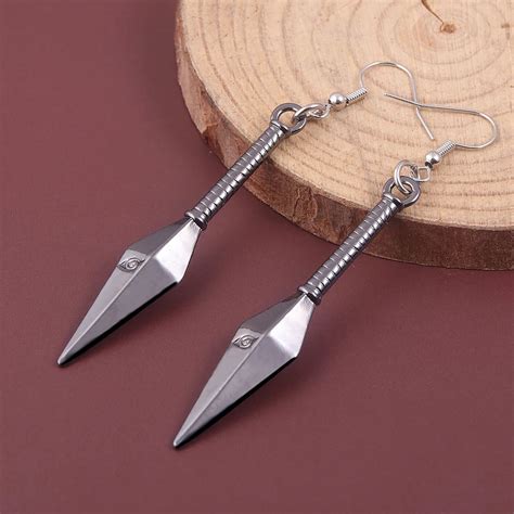Minato kunai earrings. Nov 4, 2023 · Kunai is a small black dagger, roughly the size of a hand, with a bandaged handle and a pommel-like ring. Although frequently stored in a shinobi’s weapon pouch, it can also be hidden up the sleeve of a ninja by a spring, through which the user can extend and retract at will with the help of the spring-loaded wire. 
