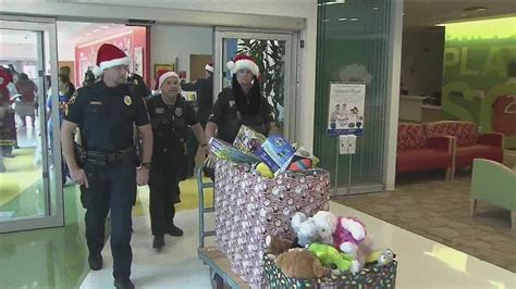 Miramar Police officers stop by Joe DiMaggio Children’s Hospital to deliver gifts in 15-year Christmas tradition