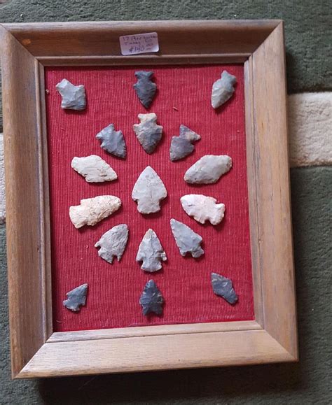 CAPTION: An assortment of prehistoric arrowheads ranging in age from PaleoIndian (10,000 to 6,000 B. C.), the six points in the left 1/2 of the group, to Archaic age (6,000 B. C. to A. D. 1), the two horizontal points to the right of center, to Late Prehistoric arrow points (1 to 1800 A. D.). Note the mineral patination, mineral deposits .... 
