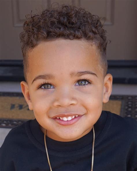 Inspiration for curly biracial boys haircuts & styles. From mixed kids' afros to boy buns, twists, cornrows and fades, we've got loads of ideas to get creative....