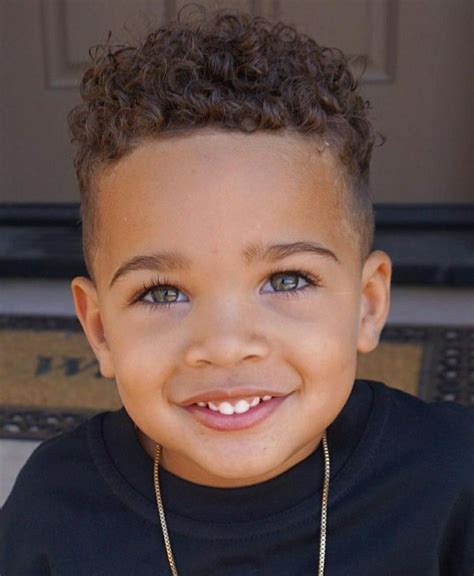 6. Baby Boy’s Undercut. If you can’t seem to come up with a hairstyle for mixed babies, you can ask a professional to cut your baby’s hair in a trendy haircut such as this one. Here, tapered fades with long hair on the crown area, makes the baby look like a miniature chic gentleman! 7. Middle Part Curls.