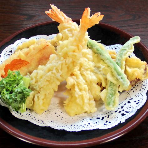 Mixed tempura. In a large container mix all ingredients of the tempura mix. Dredge all the shrimps and vegetable pieces in this dry mixture so that all shrimps are coated evenly, dust off excess powder. Pour 1 cup of icy cold water into the remain batter mix, whisk to smooth. Dip all the powder-coated shrimps and veggies into the batter. 