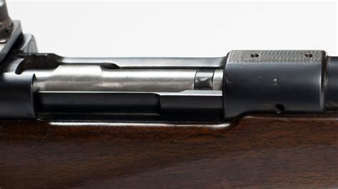 Model 70 pre 64 serial numbers. The bolt body is faintly marked “1” in electric pencil (or similar). The Fecker scope is viable and remains optically clear, with surface finish of approximately 70 percent. Serial number 2 condition: The bore remains smooth, strong and viable. Drilling and tapping for scope mounting includes 2x on the front ring. 