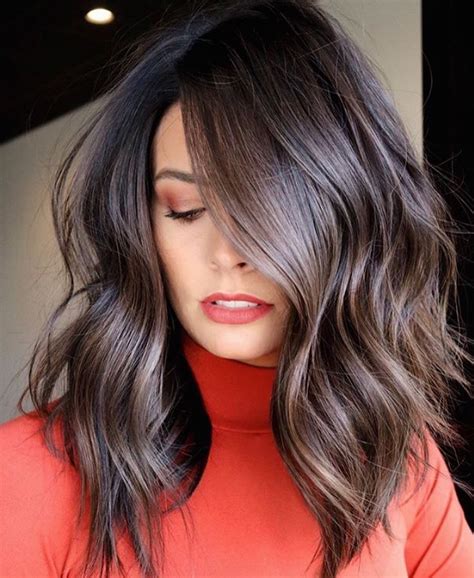 Modern haircuts. Jenna Coleman's chestnut locks look great with a cut that hits at the shoulders, has a center part, and infuses a little bit of volume at the roots. To achieve a more natural look than a dead-center part, take a cue from Coleman and go slightly off-center—about half an inch on either side of your nose. 22 of 55. 