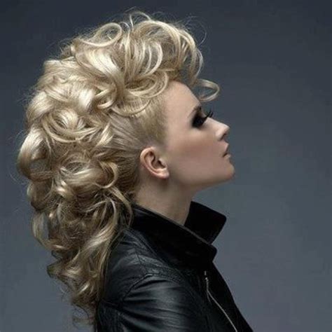 33. Faux Mohawk Black Updo Hairstyle. While this bold hairdo looks like one of the twisted black updo hairstyles, it is actually a series of knots that are intertwined to create a faux Mohawk. The part in the middle makes it easier to create a full look, but it also adds an interesting detail to the side view.