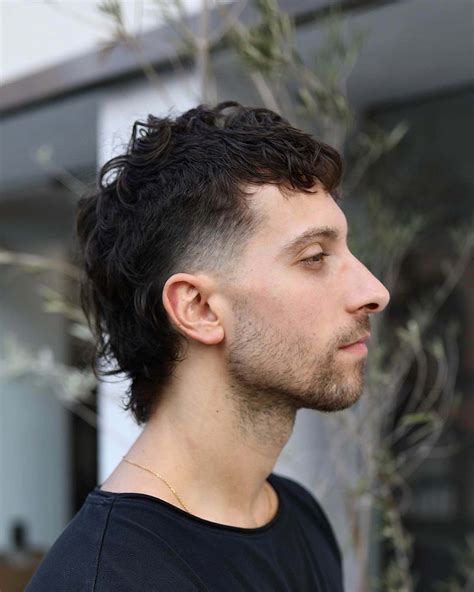 4. Curly ‘Hawk with Man Bun. Give a man bun to your little man-to-be. A little manly look does no harm! A simple little boy mohawk style with fade and top locks tied into a man bun on the back are what make this style. This look is for all hair types; wavy and straight.. 