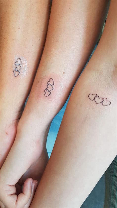 Mom and two daughters tattoo. May 13, 2018 · 23 Tiny Matching Tattoos That Will Make You and Your Mom Want to Get Inked. The bond between a mother and daughter is so incredibly special that sometimes, it's worth permanently celebrating. We ... 