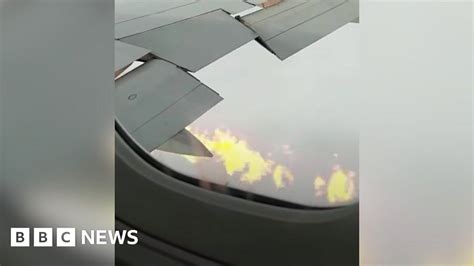 Moment plane makes landing with flames shooting …