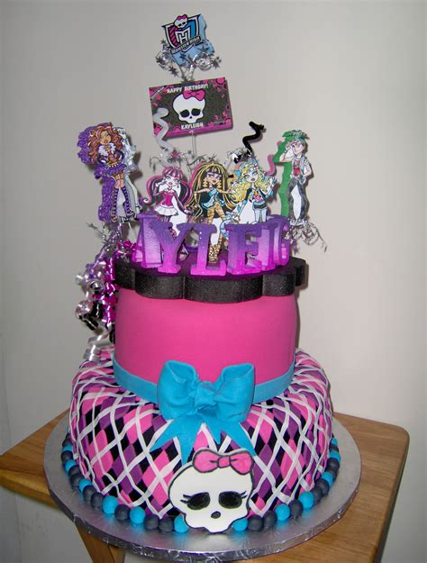 Monster high cake. Two tier Monster High themed cake with Monster High dolls. 
