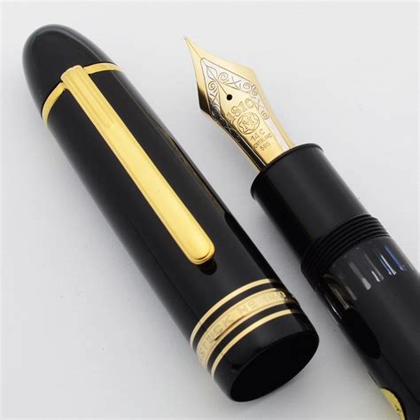 Mont blanc fountain pen. The cap and barrel are crafted in black precious resin featuring the iconic white Montblanc emblem inlaid in the cap top. The fountain pen is crowned with the innovative curved nib, hand-crafted in Au750 / 18K solid gold and garnished with three delicate parallel lines; a symbol inspired by calligraphy movements. 