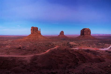 An iconic symbol of the Southwestern USA, Monument Valley is a desert landscape punctuated by red sandstone formations, slender pinnacles and massive buttes straddles the Arizona-Utah state line about 508 kilometers north of Phoenix, Arizona. Over millions of years, the forces of wind and water have sculpted this starkly fantastic land.. 