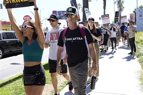 Movie and TV stars join picket lines in fight over the future of Hollywood