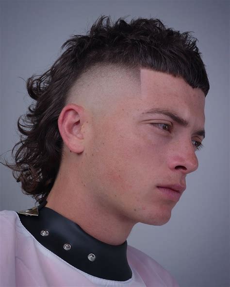 Shaved Design Mullet. From the many mullet styles, this one will draw appeal from certain individuals of the gay community. This gay haircut exposes the sides completely and doesn’t take subtlety for an answer. Lightly purple dyed feeble top hair is tagged with longer hair at the back.. 