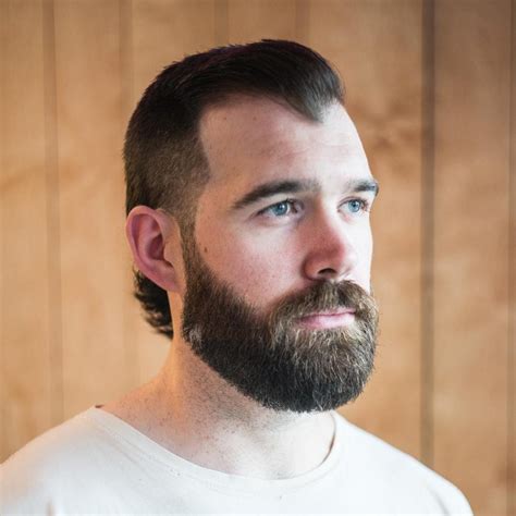 2. Short Fade With Styled Back Bangs. Improvisor/Shutterstock. A fade with bangs styled over and back is one of the best haircuts for a receding hairline. The longest portion of this cut is the bangs, which are styled over to the side and brushed back a bit to physically cover the receding zones at the temples.