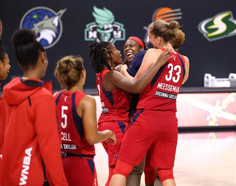 Mystics basketball. The three Washington Mystics players on hardship contracts — guard Abby Meyers (left), forward Cyesha Goree (22) and guard Linnae Harper (right) — celebrate alongside star forward/guard Elena Delle Donne (in white) during a game against the Phoenix Mercury at the Entertainment and Sports Arena in Washington, D.C., on July … 