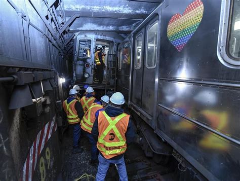 NYC subway crews wrestle derailed train back on tracks, as crash disrupts service for second day
