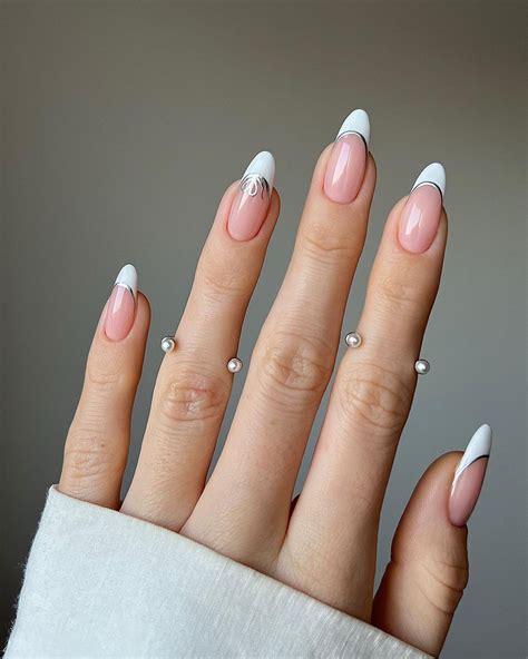 Nail ideas 2024. Classic French Tip Two-Tone Nail Design. The classic French two-tone nail design is a timeless style you’ll absolutely love for its simplicity and elegance. This nail look uses a two-tone manicure technique that perfectly balances two contrasting nail colors, creating a sophisticated and chic look. The beauty of the classic French manicure ... 