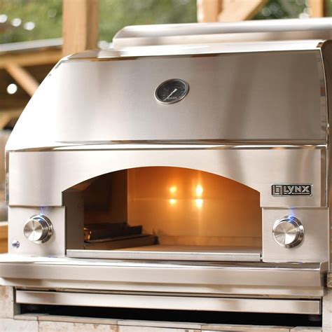 Napoli pizza oven. Features. Serve flavorful stone-baked dishes from this Napoli outdoor oven. Its 400 sq. in. cooking surface lets you bake large entrées, and 40,000 BTUs of power provides ample heating. This Napoli outdoor oven is on a kitchen cart for easy mobility and has storage cabinets and drawers for access to ingredients and tools. 