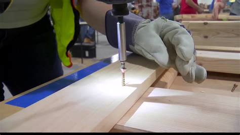 National Grid employees help build bed frames for kids in need