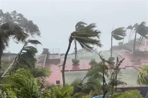 National Weather Service says Typhoon Mawar passing over Guam as Category 4 storm with strong winds, rain