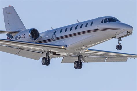 Company profile page for NetJets Inc including stock price, company news, executives, board members, and contact information 