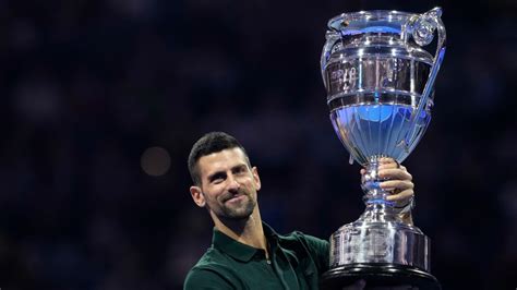 Novak Djokovic gets his trophy after securing year-end No. 1 ranking for a record-extending 8th time