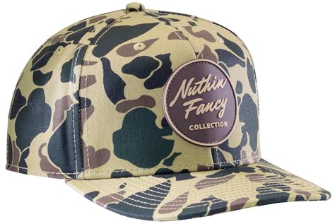 Nuthin fancy hat. Hickory Snapback. $40.00. Shipping calculated at checkout. Brown and olive snapback w/ brown mesh back. Brown & olive logo patch. Olive under bill. Pre-curved bill. Plastic snap adjust. One size fits most. 