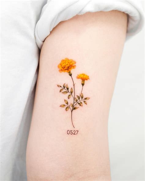If you’re thinking of incorporating your own birth month flower into a tattoo and you’re an October baby, cosmos and marigold are your go-to blooms. Cosmos, with its symmetrical petals and sweet scent, is a symbol of peace, order, and harmony. The name cosmos itself is derived from the Greek word for a balanced universe.. 
