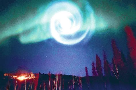 Odd spiral appears amid northern lights in Alaska night sky. No, it wasn’t aliens or a stargate.