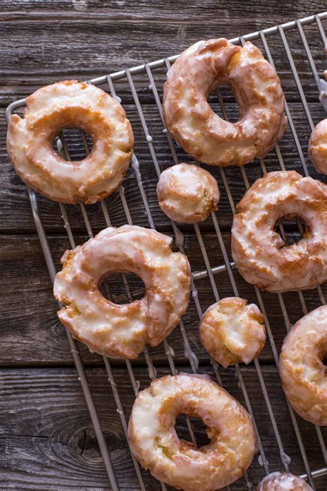 Old fashioned donuts. Preheat your oven to 425°F (218°C) and lightly grease your donut pans or mini-donut pans. In a medium-sized mixing bowl, add the room temperature softened butter, cooking oil, sugar, and light brown sugar. Cream together the wet ingredients, then add the beaten eggs, baking powder, vanilla extract, and salt. 