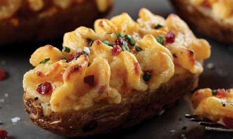 Layer potatoes in prepared pan. Stir together heavy cream, garlic, salt, and pepper. Pour over potatoes. Top with 1 cup Gruyere cheese. Bake for 30 minutes, stirring every 10 minutes. Sprinkle with remaining cheese and bake an additional 15 minutes, or until golden brown and bubbly.. 