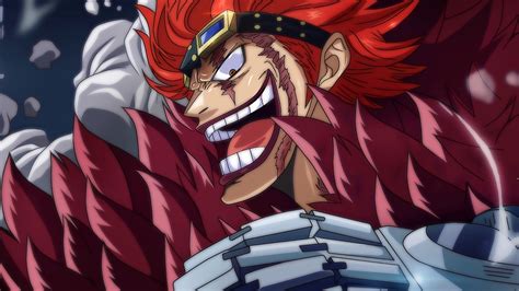 One piece kid. Kid is a tall, muscular man with light skin and bright red hair, resembling flames. His nose has a particular shape, being quite pointed and having little protrusions on both sides. He has dark reddish, purple-colored lips and fingernails, red/orange eyes and no eyebrows. 