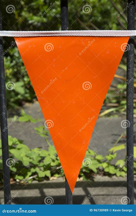 Orange triangle flag. .  <a href=https://staging-statamic.stillstream.ai/asse...