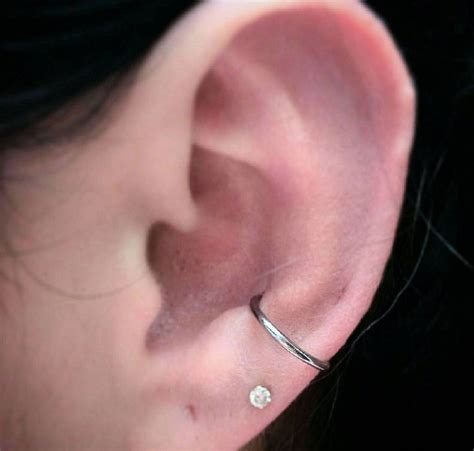 Orbital piercing. The orbital piercing is similar to the industrial placement (one of the most painful piercings) but has the pain level of a helix piercing. It also has a shorter healing window than both piercings. The orbital piercing consists of two holes connected by a hoop. You can choose to get the placements on the lower portion of your helix or the ear lobe. 